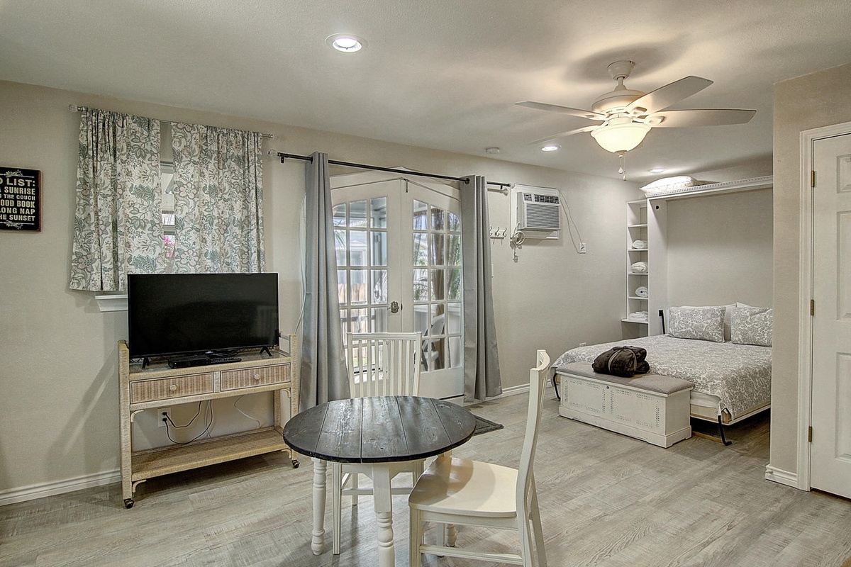 Step into your stylish studio where comfort meets convenience. Relax in the seating area, unwind on the cozy bed, and enjoy entertainment on your flat-screen TV.