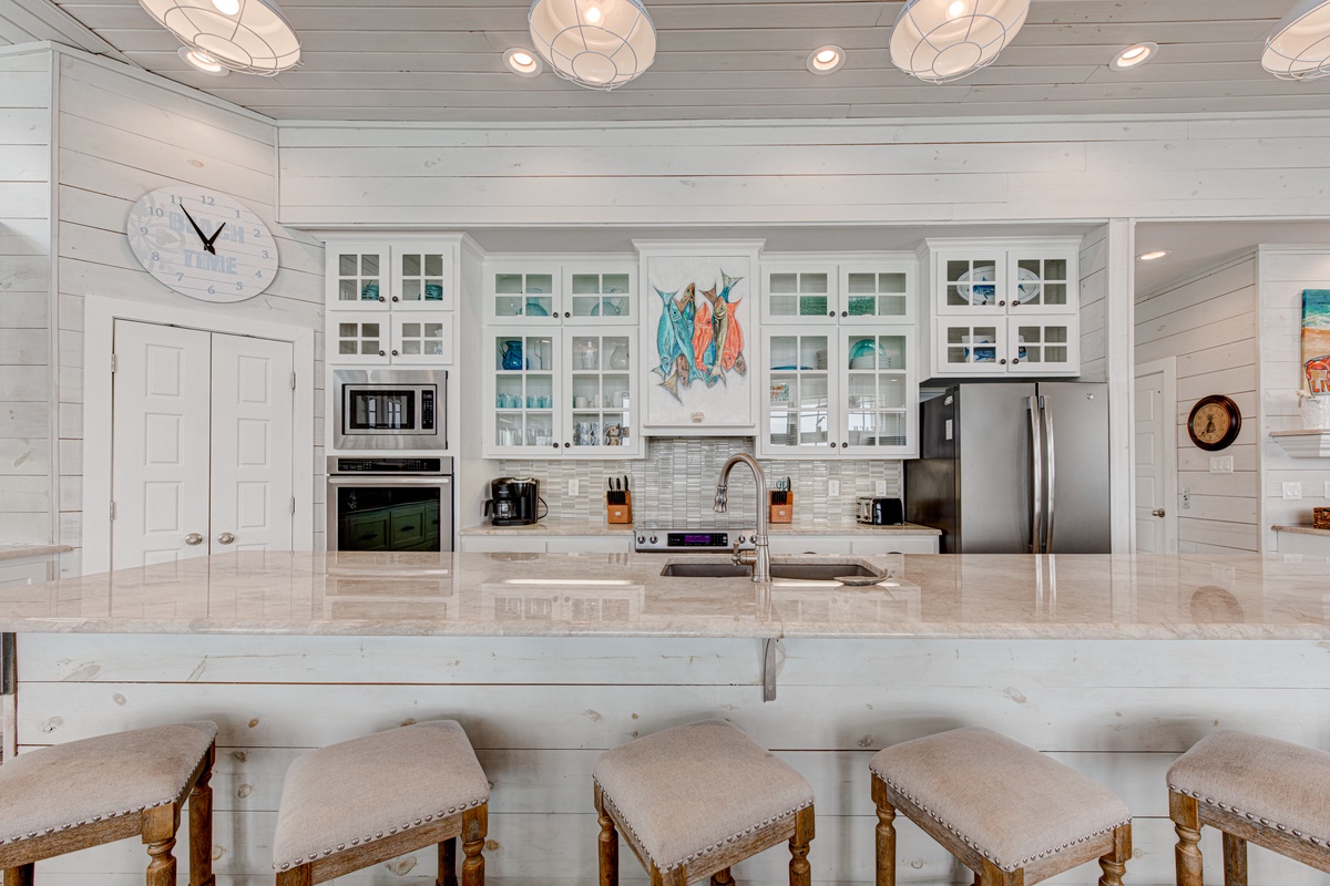 Your dream kitchen awaits with gleaming countertops, premium appliances, and coastal charm that makes every meal special.