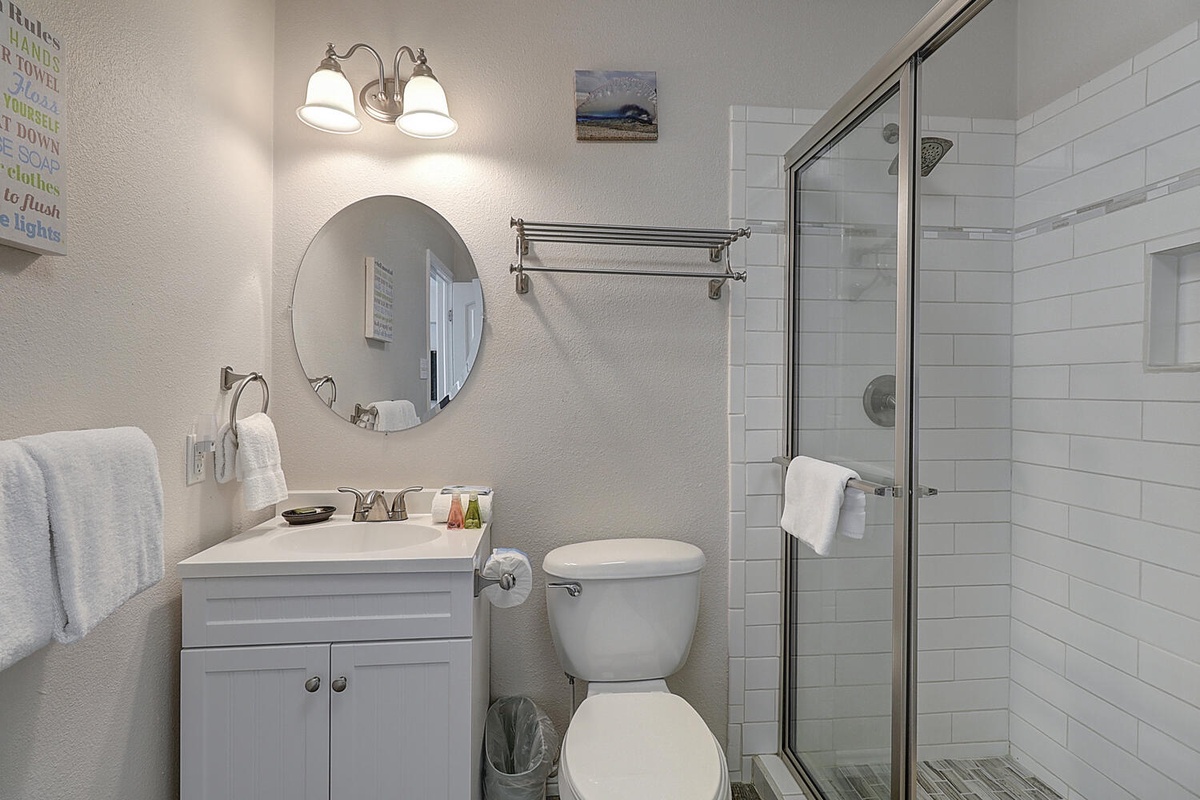 Step into your crisp, well-appointed bathroom featuring clean subway tiles, modern fixtures, and thoughtful touches like fresh towels awaiting your arrival.