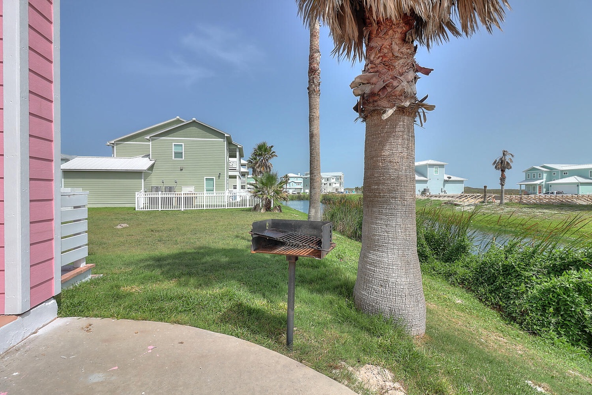 Fire up the grill and savor your coastal cookout under swaying palms, with colorful beach houses as your backdrop.