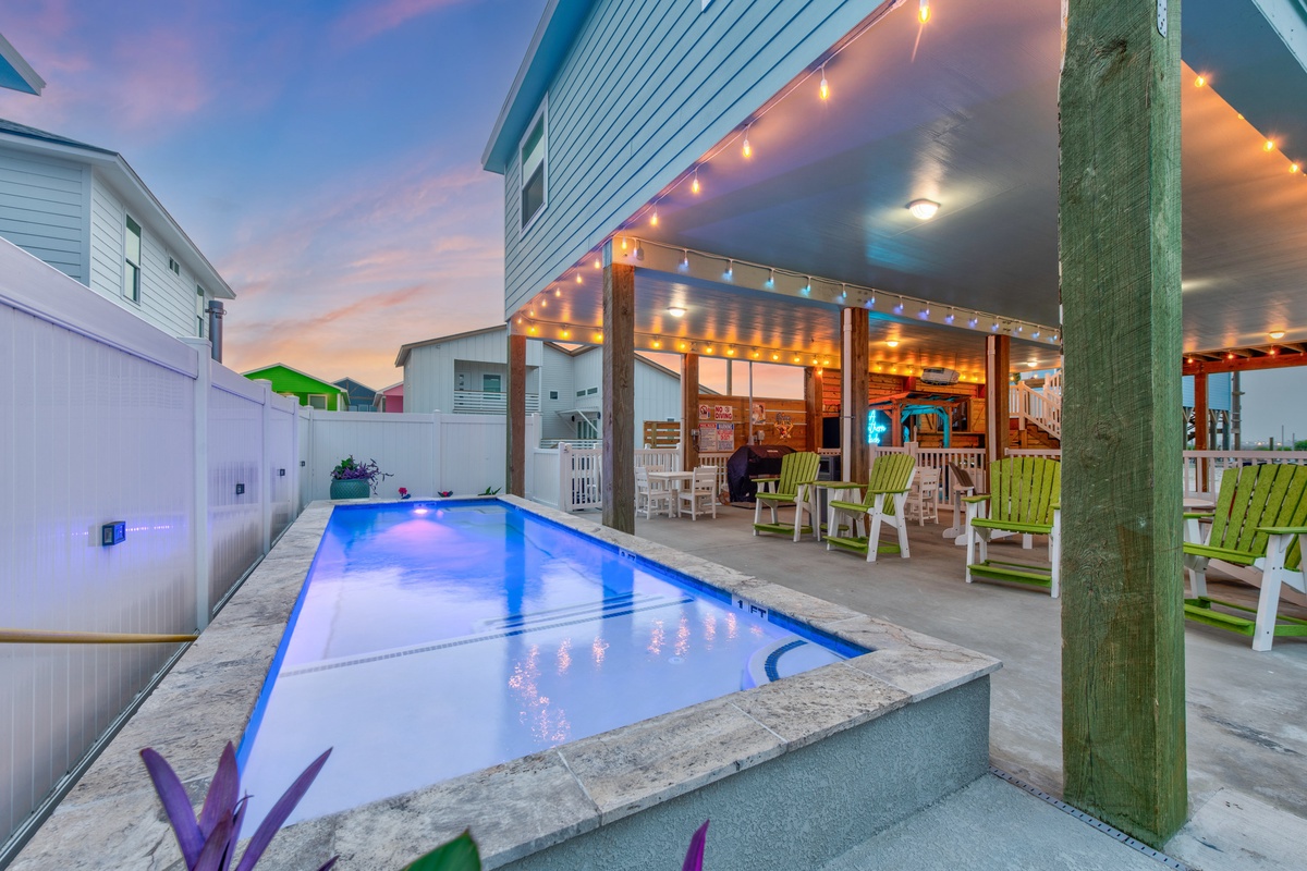 Dive into your private pool oasis as twilight paints the sky, where twinkling lights create magical ambiance for evening swims and poolside relaxation.