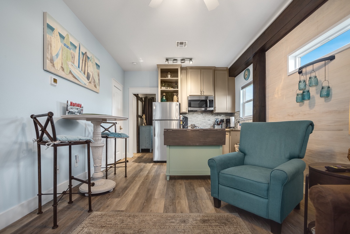 Your cozy retreat blends modern comfort with coastal charm, featuring a fully equipped kitchen and inviting living space perfect for relaxing.