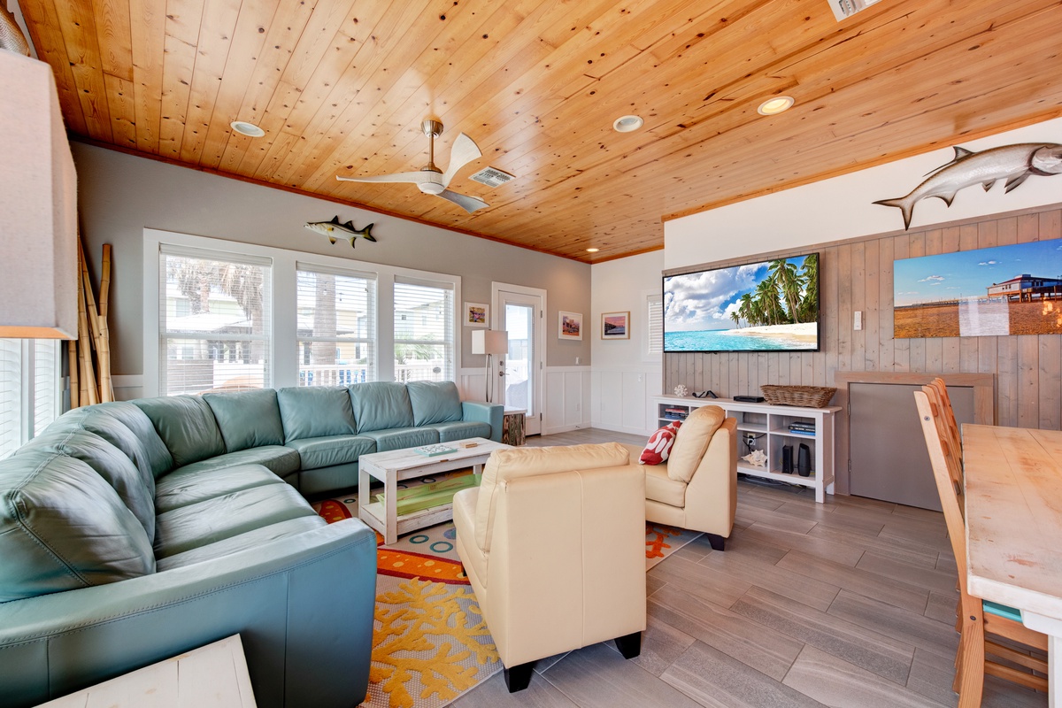 Sink into the plush sectional and enjoy movie nights under beautiful wood ceilings in your spacious living room.