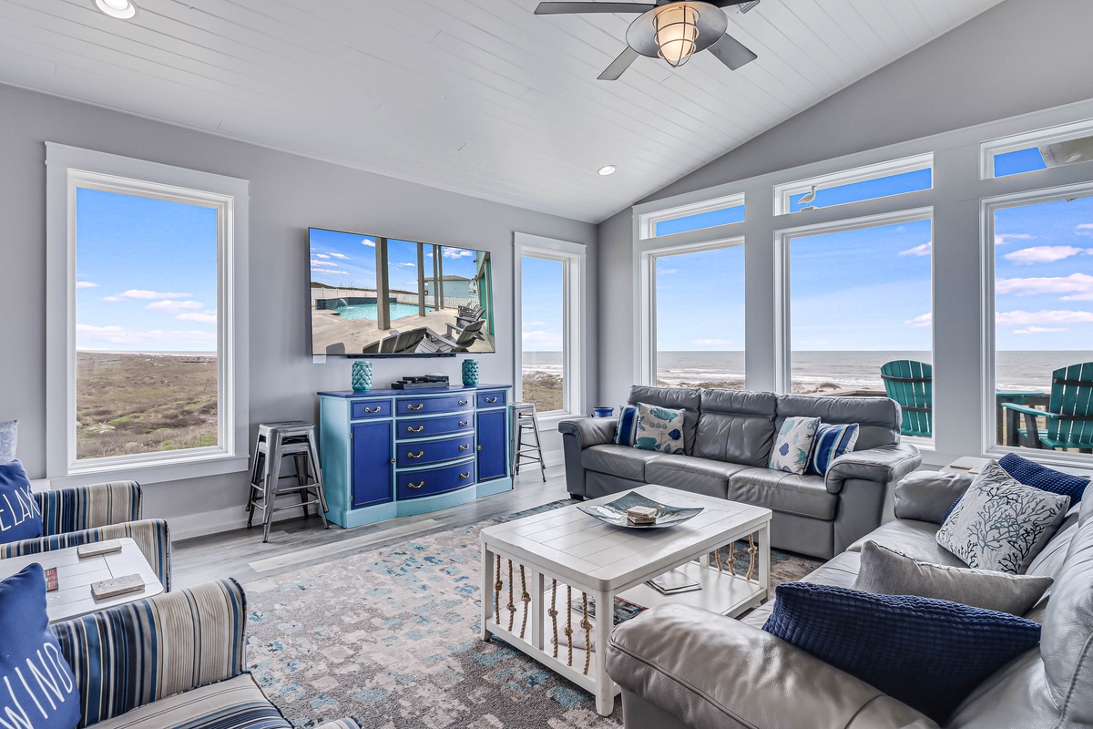 Sink into plush sectional seating while panoramic ocean views fill every window, creating your perfect coastal retreat.
