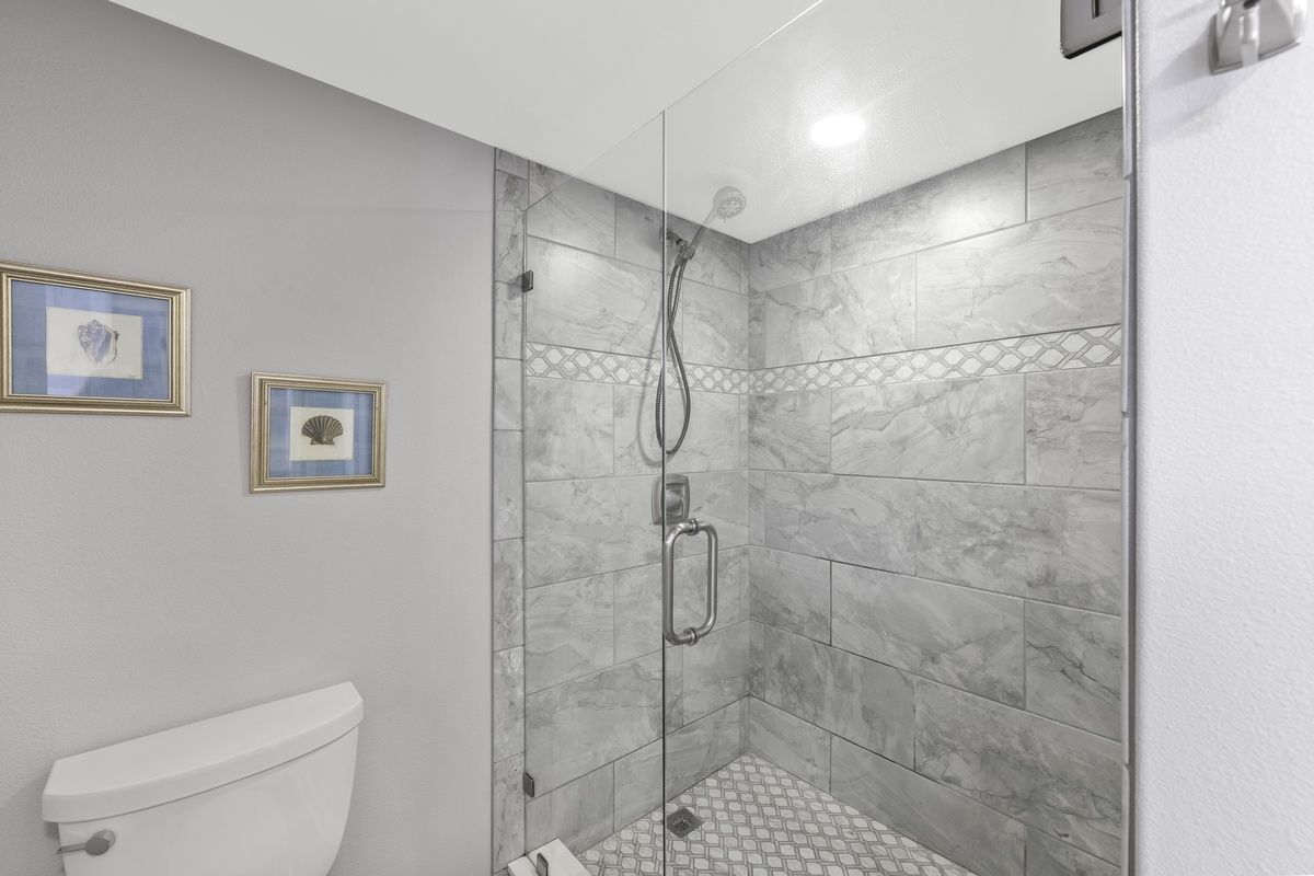 Indulge in your private spa-like retreat with marble-tiled walk-in shower and elegant finishes.