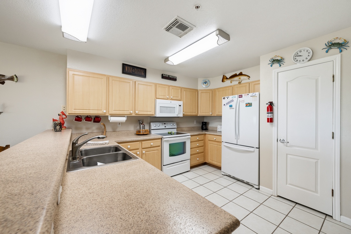 Your spacious kitchen awaits with everything you need to create memorable meals—granite counters, full appliances, and charming coastal touches that add a welcoming feel to your home away from home.