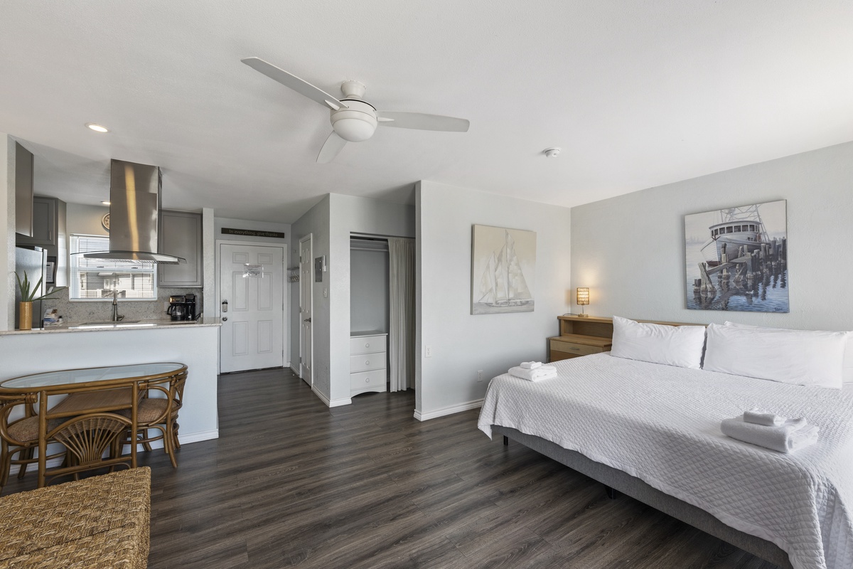 Your spacious studio seamlessly blends comfort and style with a plush bed, fully equipped kitchen, and coastal-inspired artwork creating your perfect retreat.