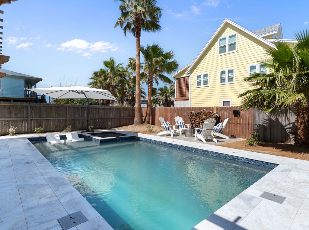 Your private poolside paradise awaits with crystal-clear waters, comfortable lounge chairs, and swaying palms creating the perfect tropical escape.
