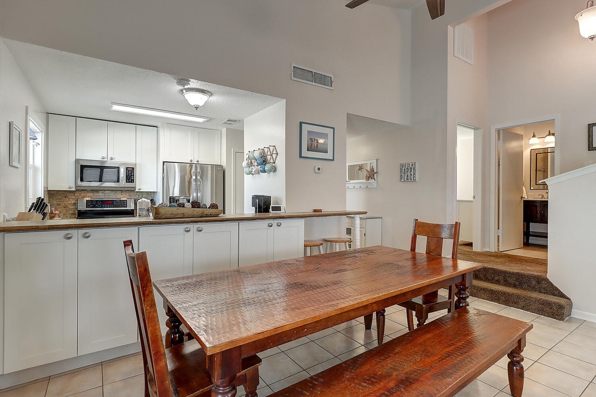Your spacious kitchen and dining area invites memorable meals with modern appliances and warm wood furnishings.
