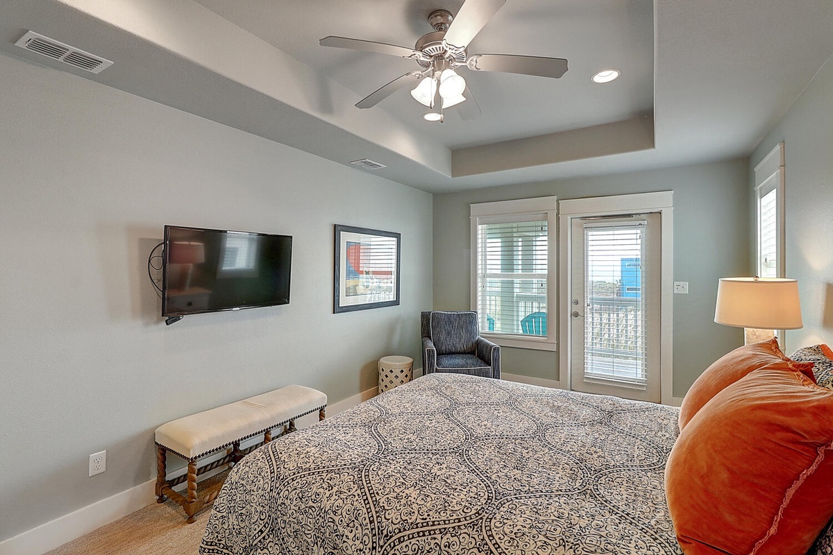 Your peaceful bedroom retreat features cozy seating, ceiling fan comfort, and French doors opening to your private balcony.