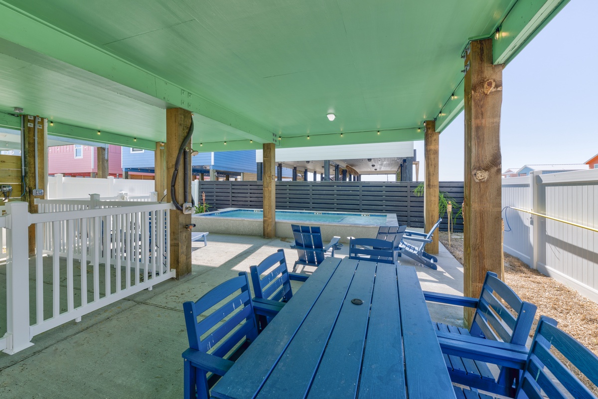 Gather with loved ones at your private blue dining table, where ocean breezes flow through this covered patio overlooking the sparkling pool.