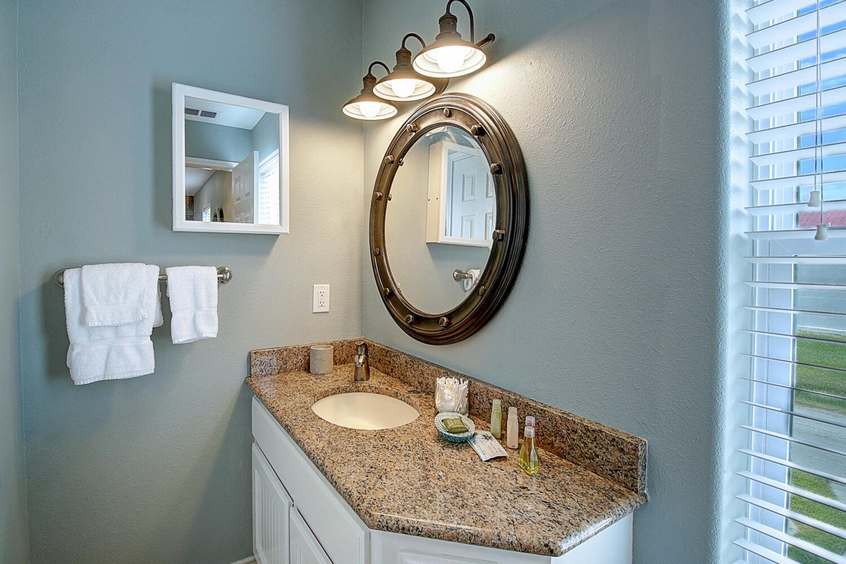 Your elegant bathroom features granite counters, stylish lighting, and fresh towels for your comfort.