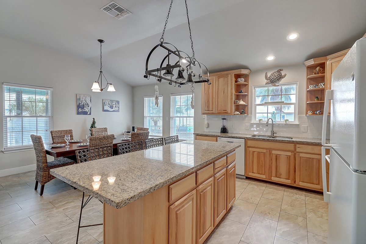 Your spacious kitchen with granite island invites leisurely meal prep, while the adjacent dining table offers the perfect spot for memorable gatherings.