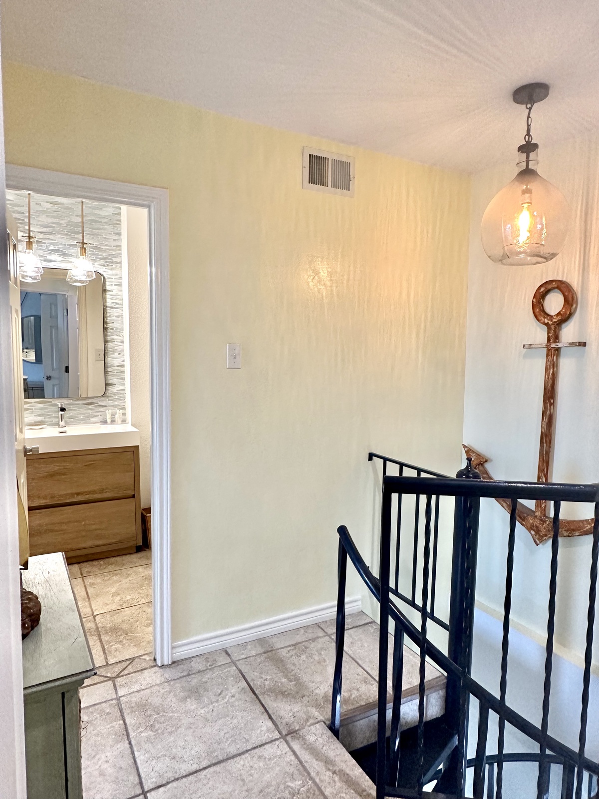 Warm lighting illuminates your upstairs landing, where nautical touches and a modern bathroom await your arrival.