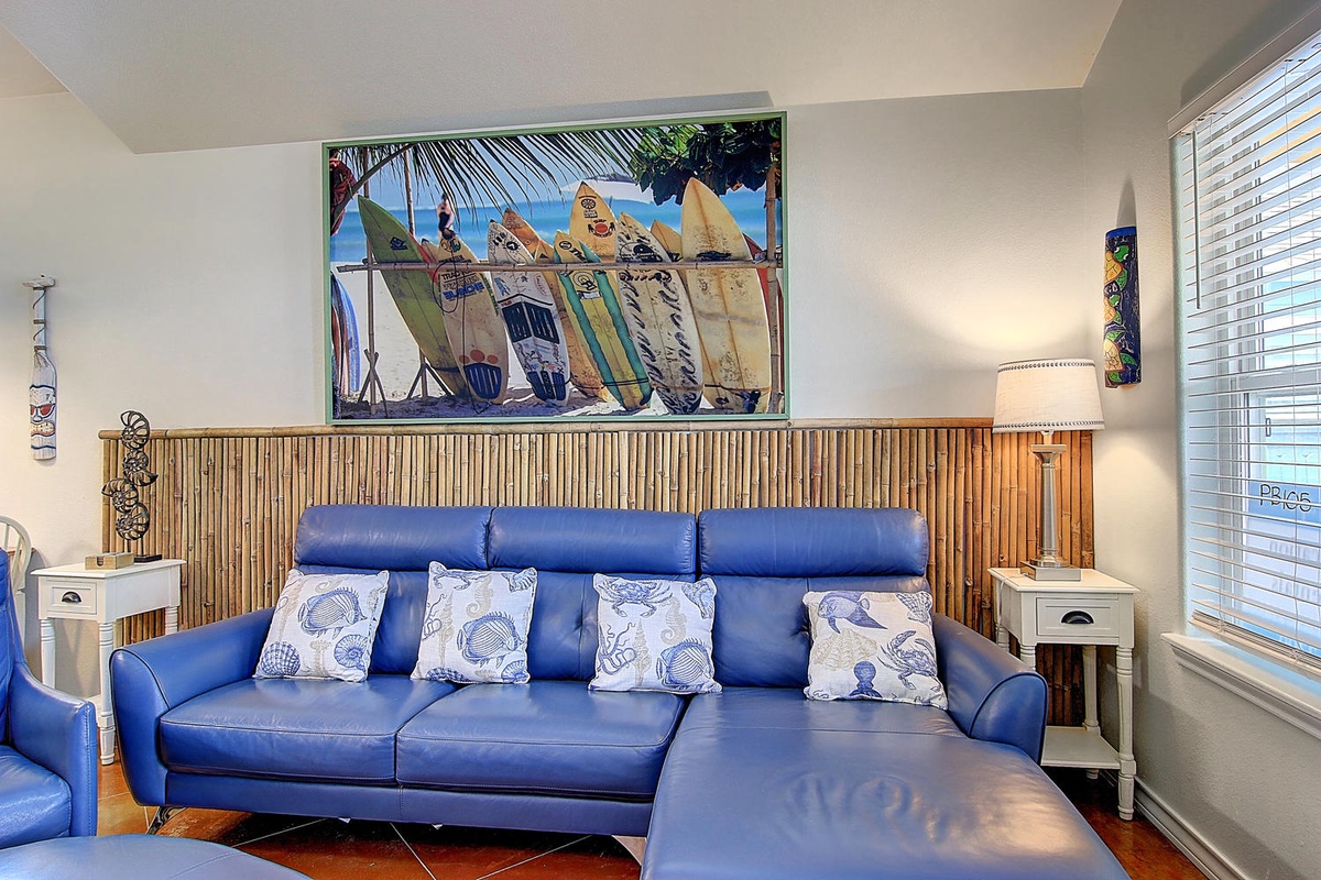 Sink into your coastal-themed living room where bamboo accents and surf art transport you to beach vibes.