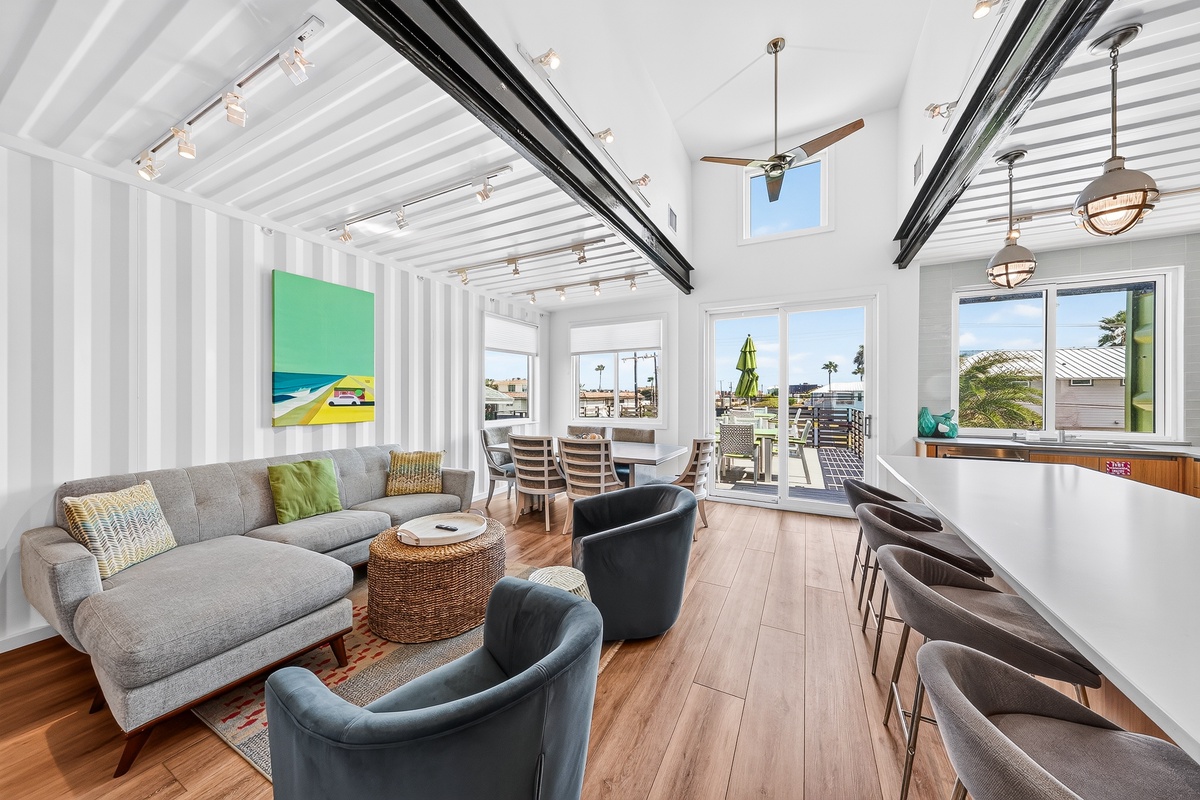 Bright, open-plan living space where comfort meets coastal style. Sink into the sectional, dine together, or gather at the kitchen bar under airy ceilings flooded with natural light.
