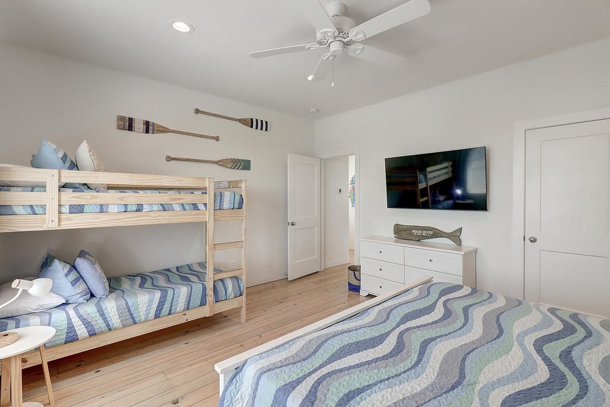 Your nautical-themed bedroom features cozy bunk beds and comfortable sleeping for the whole family, complete with wall-mounted TV for evening entertainment.