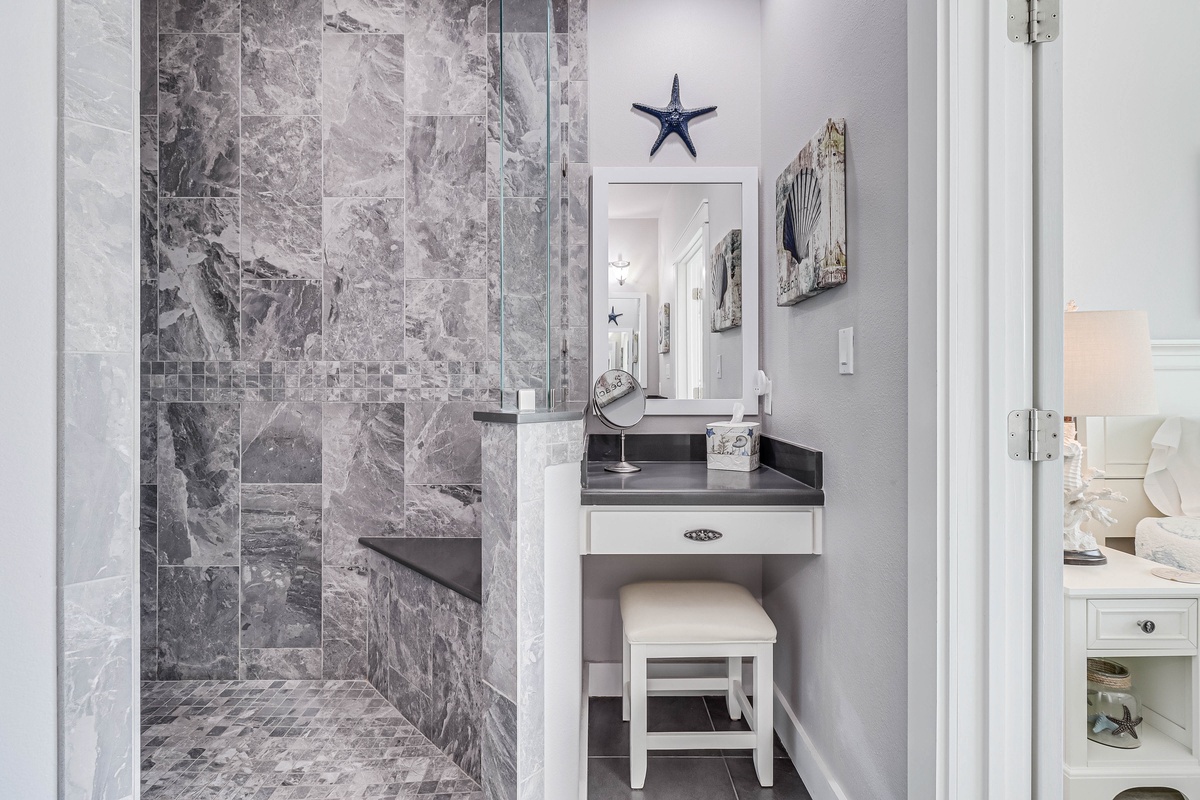 Your private ensuite features elegant marble finishes and a built-in vanity where you can prepare for coastal adventures.