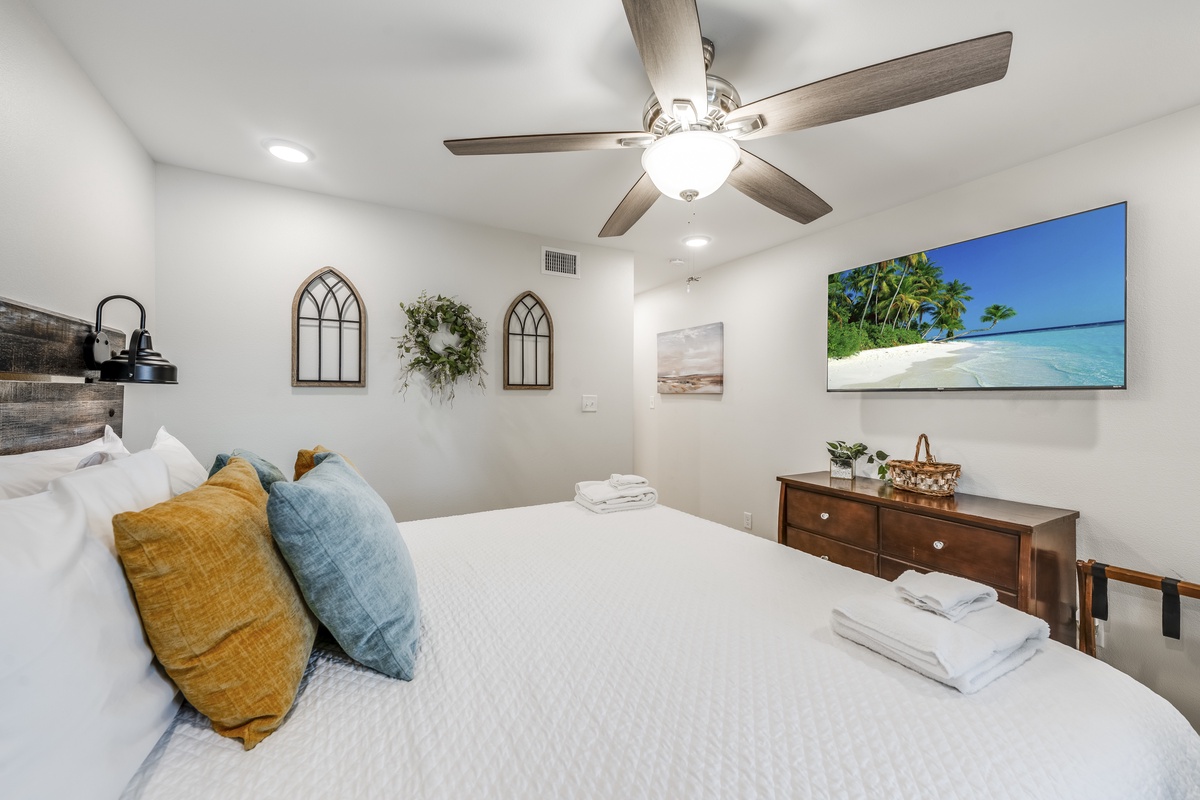 Drift off under the gentle whir of your ceiling fan, surrounded by coastal-inspired décor and tropical artwork that transports you to paradise.