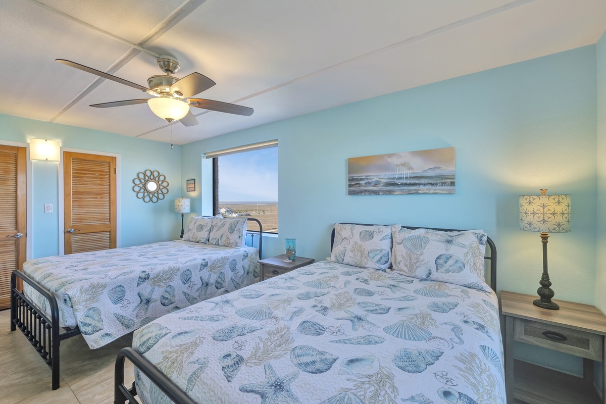 Unwind in your tranquil coastal bedroom with ocean-themed bedding and soothing blue walls that invite restful sleep.