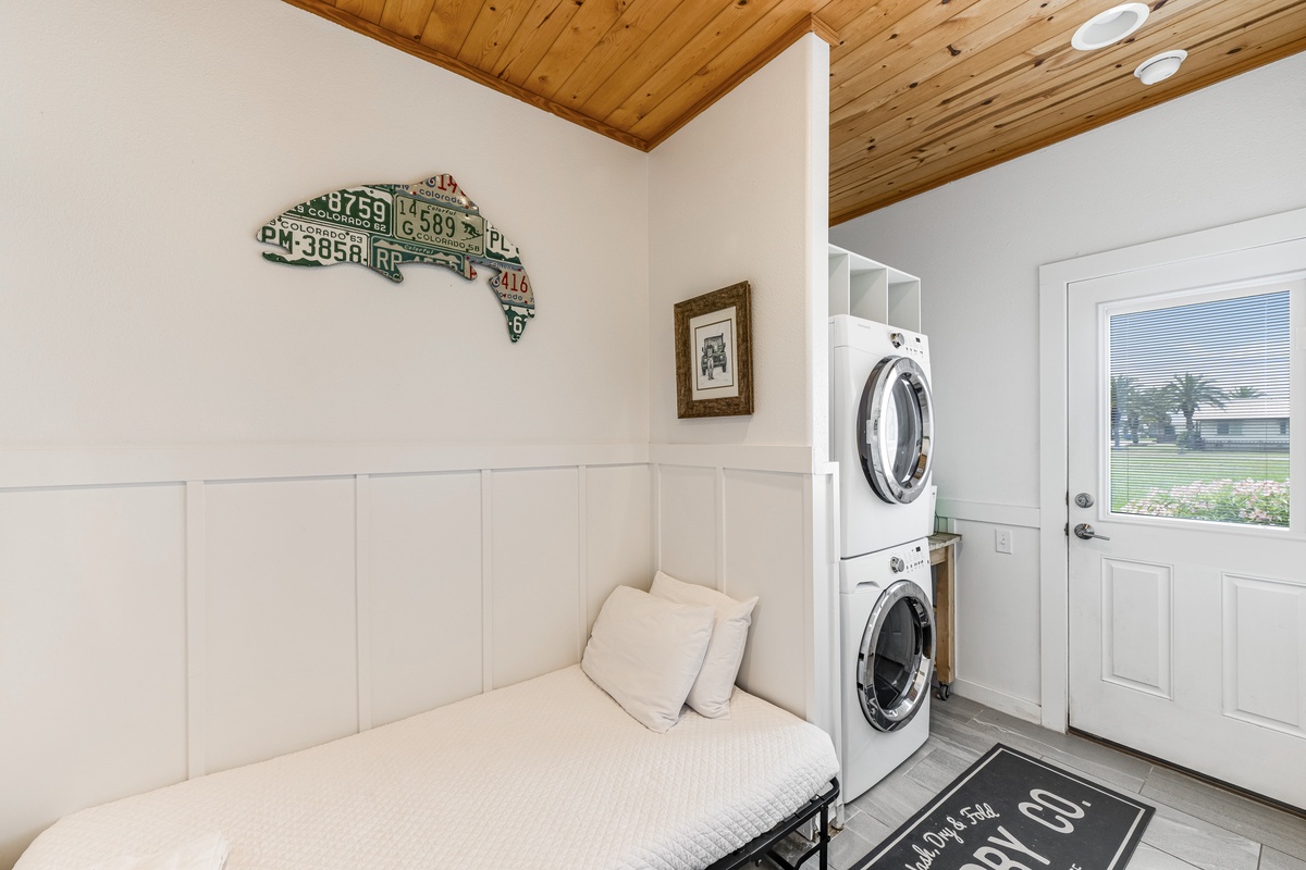 Cozy sleeping space with twin size rollway and easy access to the washer and dryer in the home.