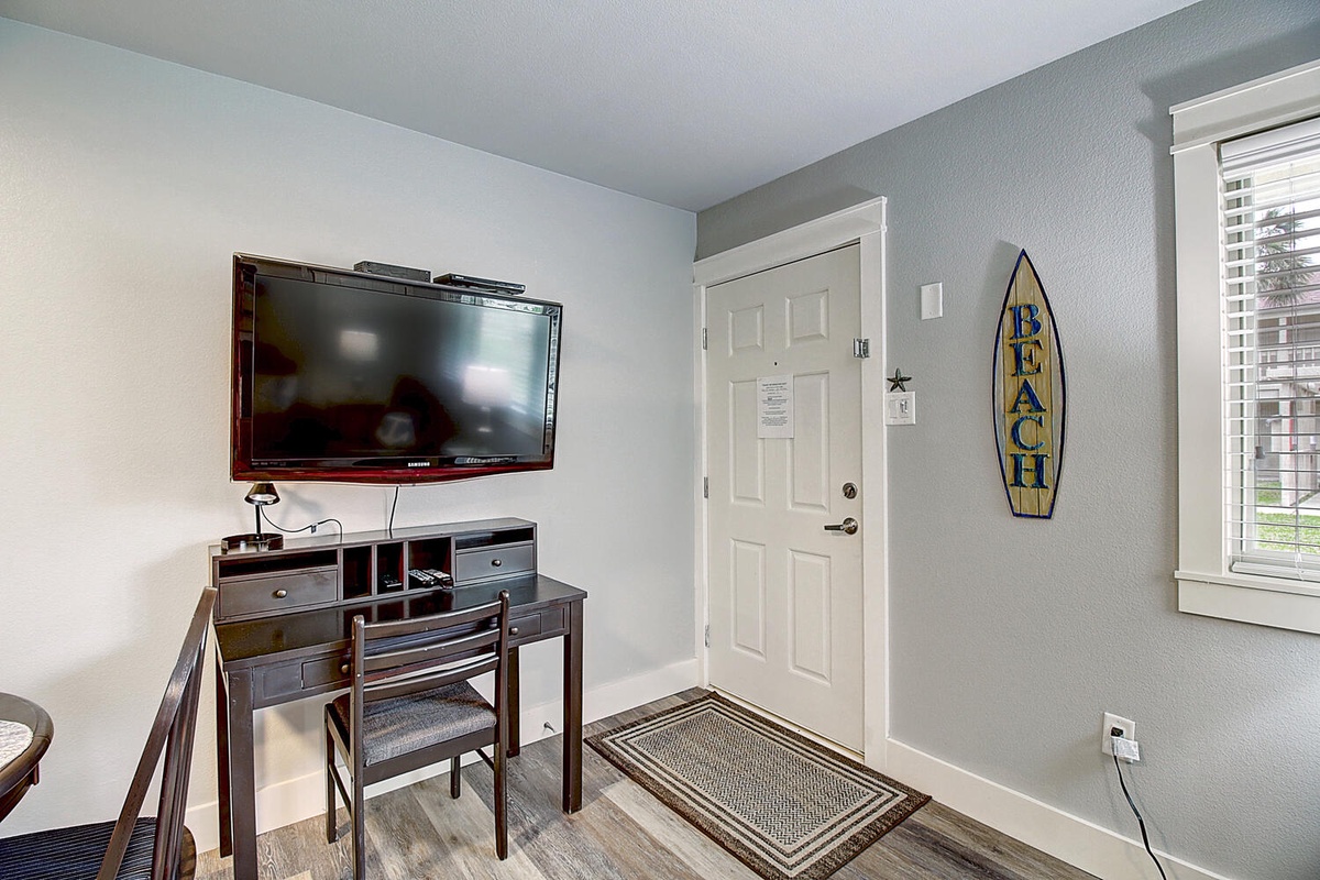 Relax in your coastal retreat with beach decor and modern entertainment center perfect for unwinding after seaside adventures.