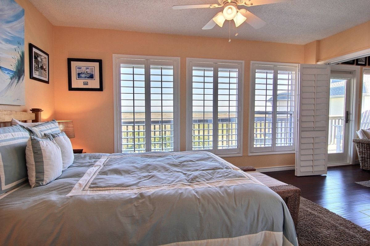 Wake up to mountain views in your serene master bedroom with soaring ceilings, plantation shutters, and private balcony access.