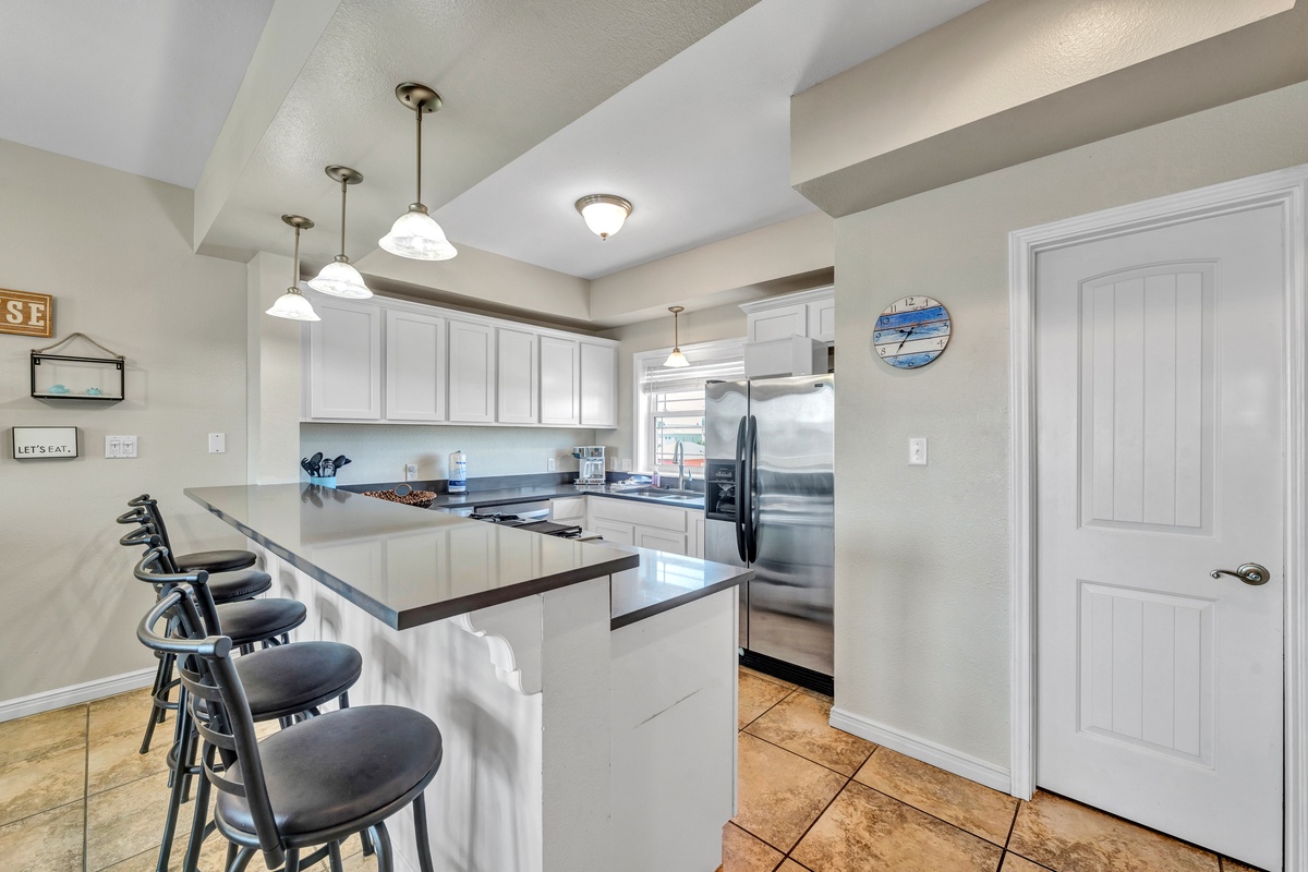 Your spacious kitchen features a breakfast bar where you can sip morning coffee and plan your coastal adventures together.