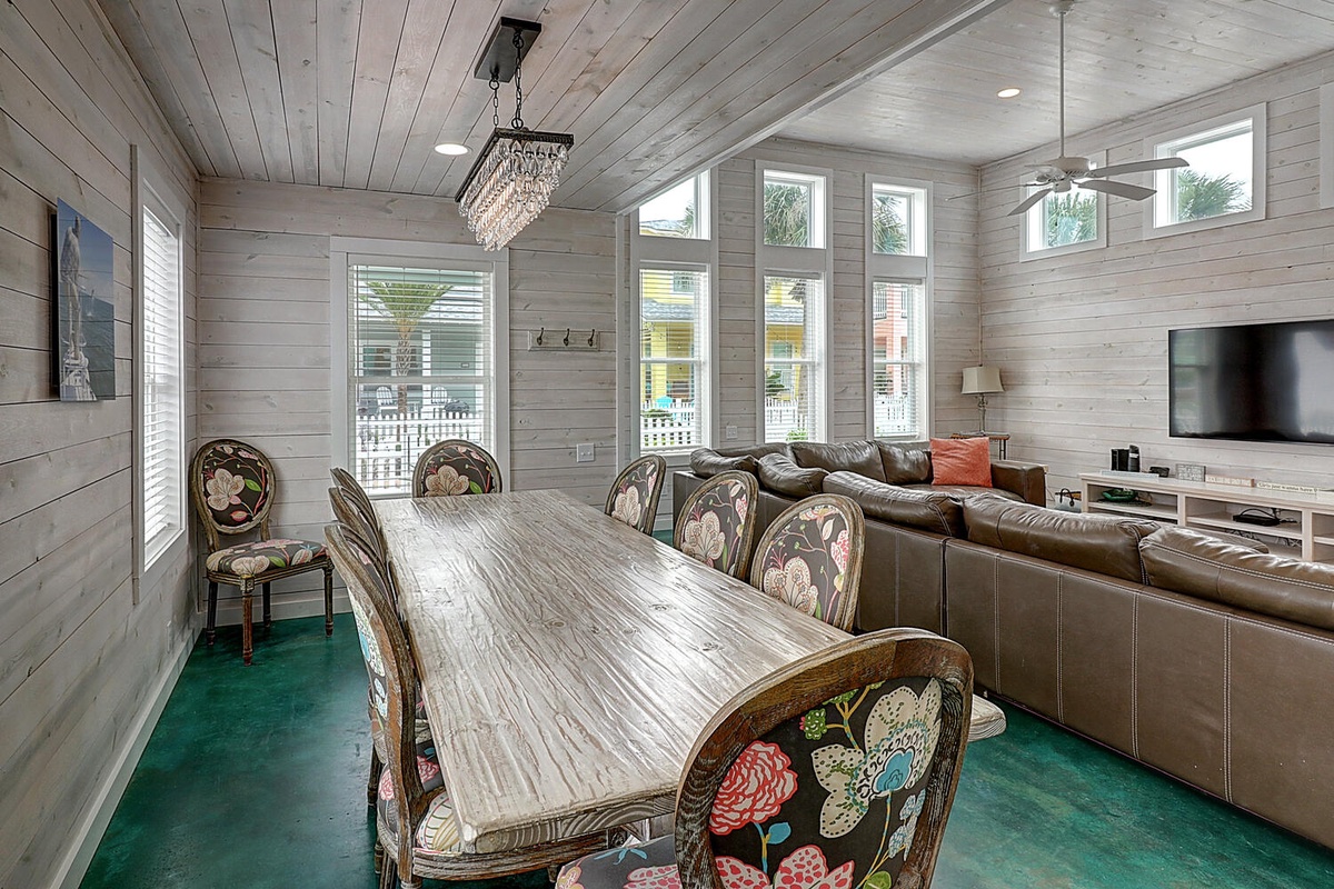 Gather around this stunning dining table while soft light filters through large windows, creating the perfect atmosphere for memorable meals together.
