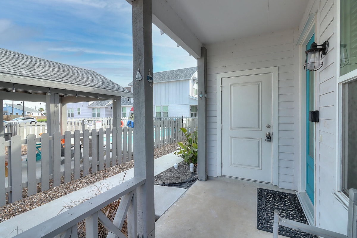 Modern coastal entrance welcomes arrivals to this beachside community retreat with clean architectural lines and neighborhood charm.