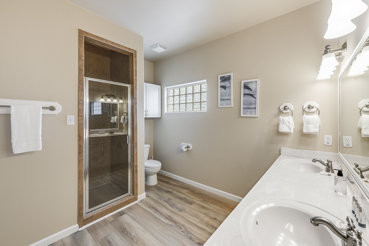 Refresh in your spacious bathroom with double vanities, separate shower, and warm wood accents that create a spa-like retreat.