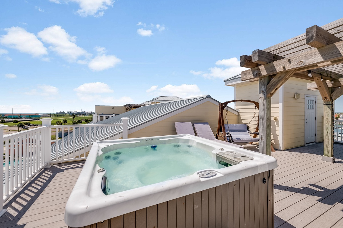 Soak in your private rooftop hot tub while enjoying panoramic views of the coastline and blue skies above.
