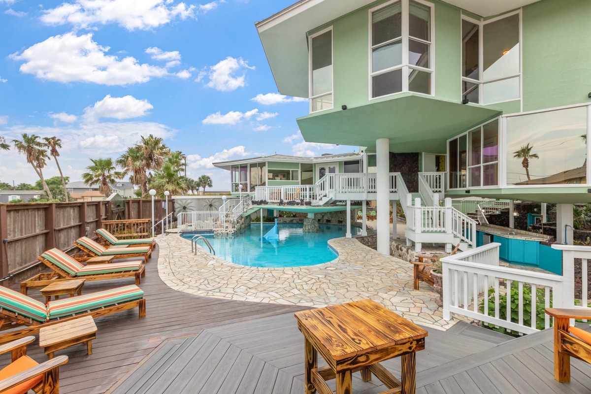 Relax by your private tropical oasis with sparkling pool, sunny deck loungers, and palm-fringed views perfect for unforgettable vacation moments.