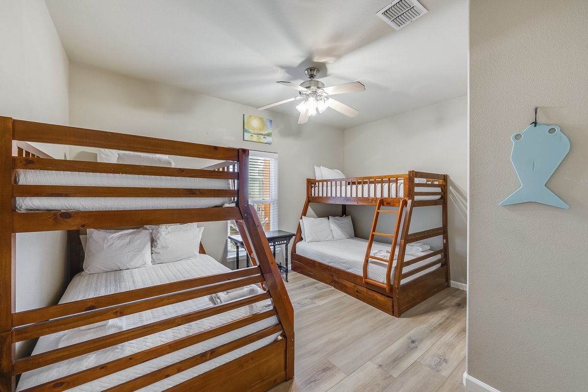 Your kids will love this bright bunk room with crisp linens and playful whale decor, perfect for creating vacation memories.