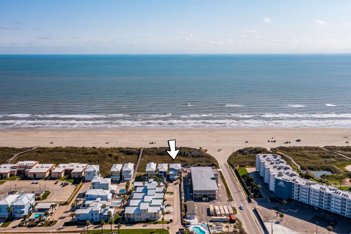 Stunning beachfront location with pristine sandy shores and turquoise waters just steps from the property entrance.