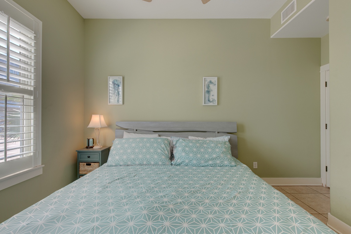 Sink into soft linens and wake refreshed in this serene bedroom, where calming mint tones and gentle natural light create your perfect retreat.