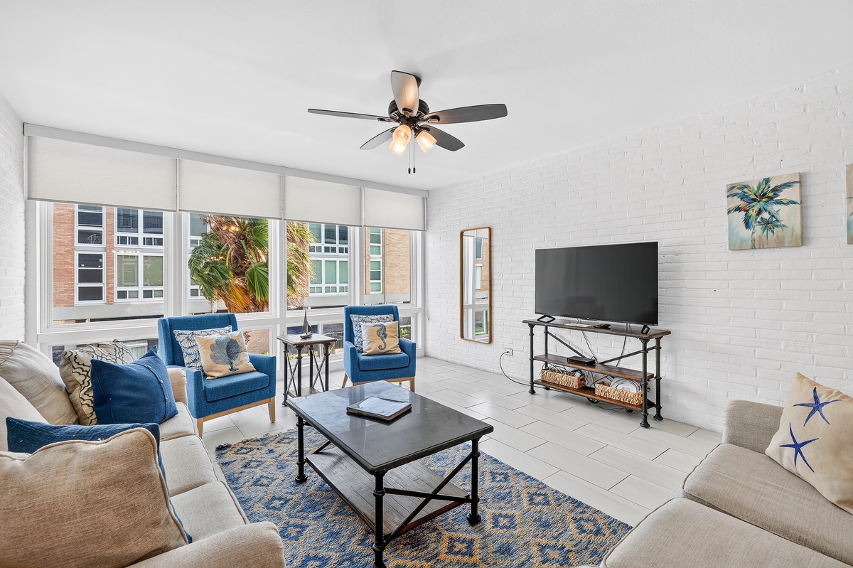 Sink into plush seating and let coastal breezes drift through your bright, airy living room—your perfect spot to unwind after beachside adventures.