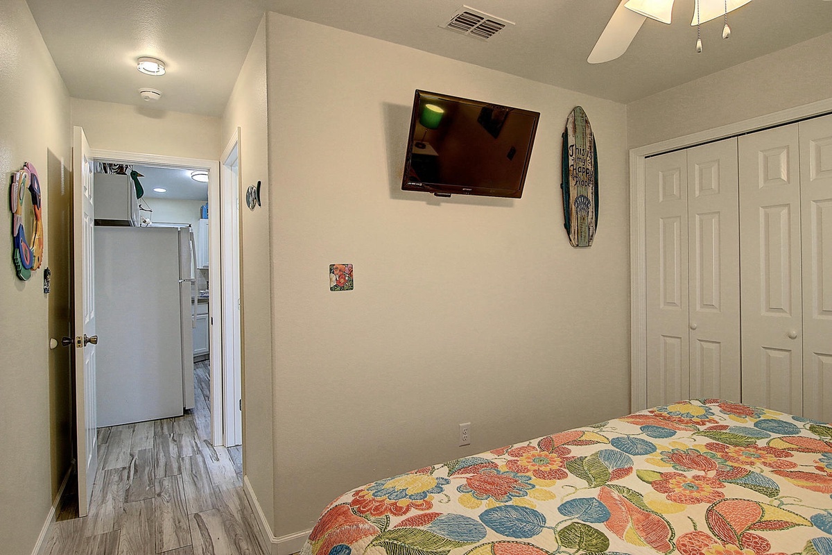 Unwind in your cozy bedroom with cheerful bedding, wall-mounted TV for entertainment, and spacious closets for all your belongings.