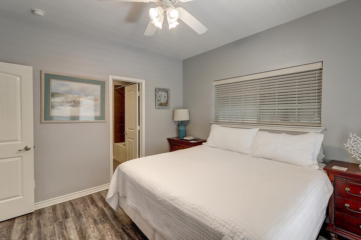Slip into crisp white linens in your peaceful bedroom, where soft lighting and thoughtful touches create the perfect retreat for restful nights.