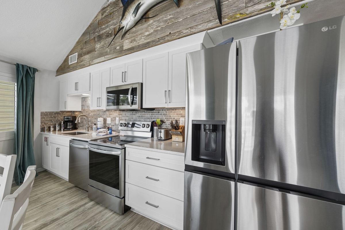 Your modern kitchen offers sleek stainless appliances and warm rustic beams, creating the perfect space for cooking memorable meals.