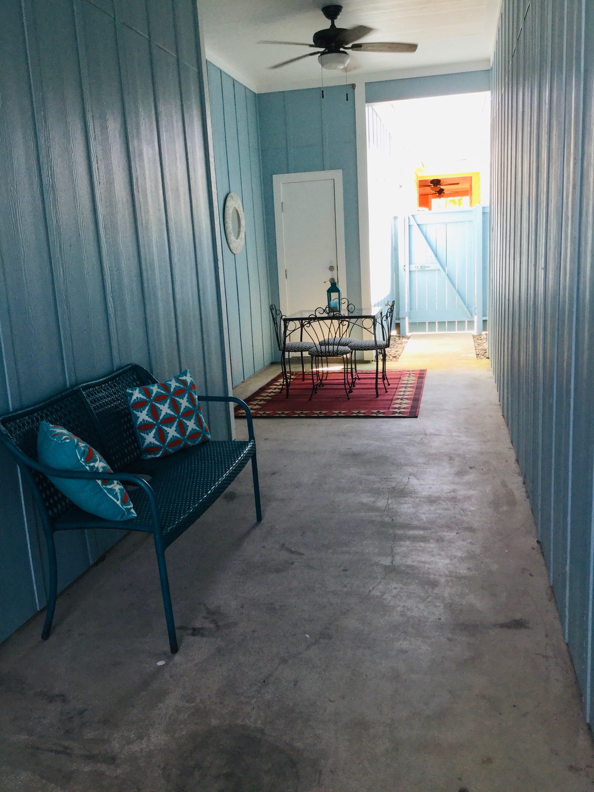 Relax on your private covered patio with coastal blue charm, where morning coffee and evening conversations flow naturally in this peaceful retreat.