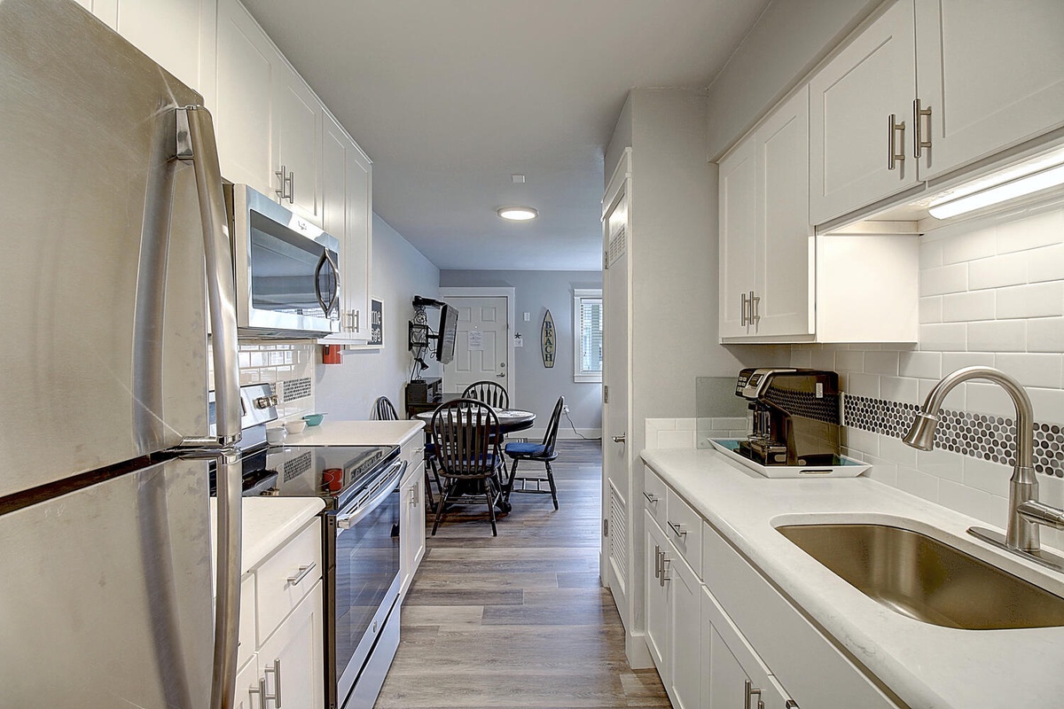 Your fully-equipped galley kitchen features stainless steel appliances and crisp white cabinetry, perfect for preparing meals during your stay.