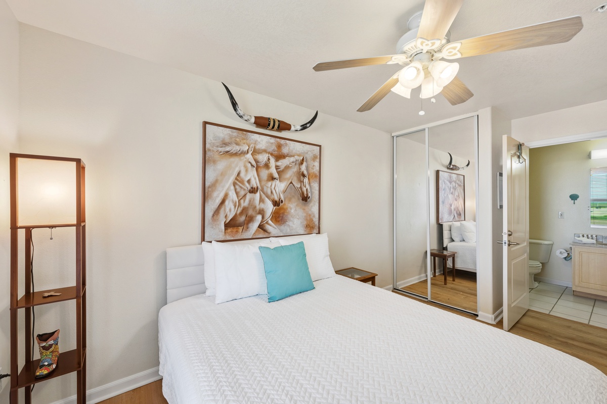 Rest easy in your cozy queen bedroom, where a ceiling fan keeps you comfortable and a peaceful atmosphere invites restful nights.