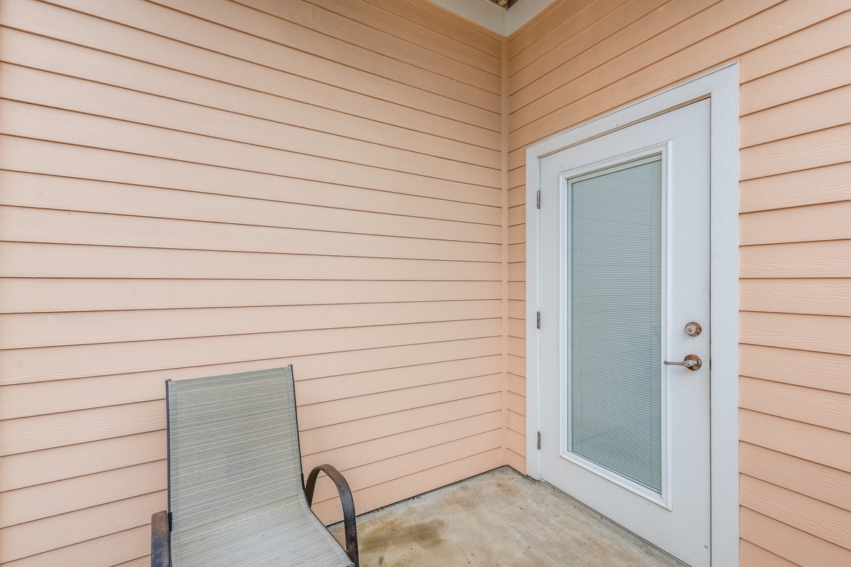 Covered entrance with seating provides a welcoming arrival spot and peaceful outdoor moment during your stay.