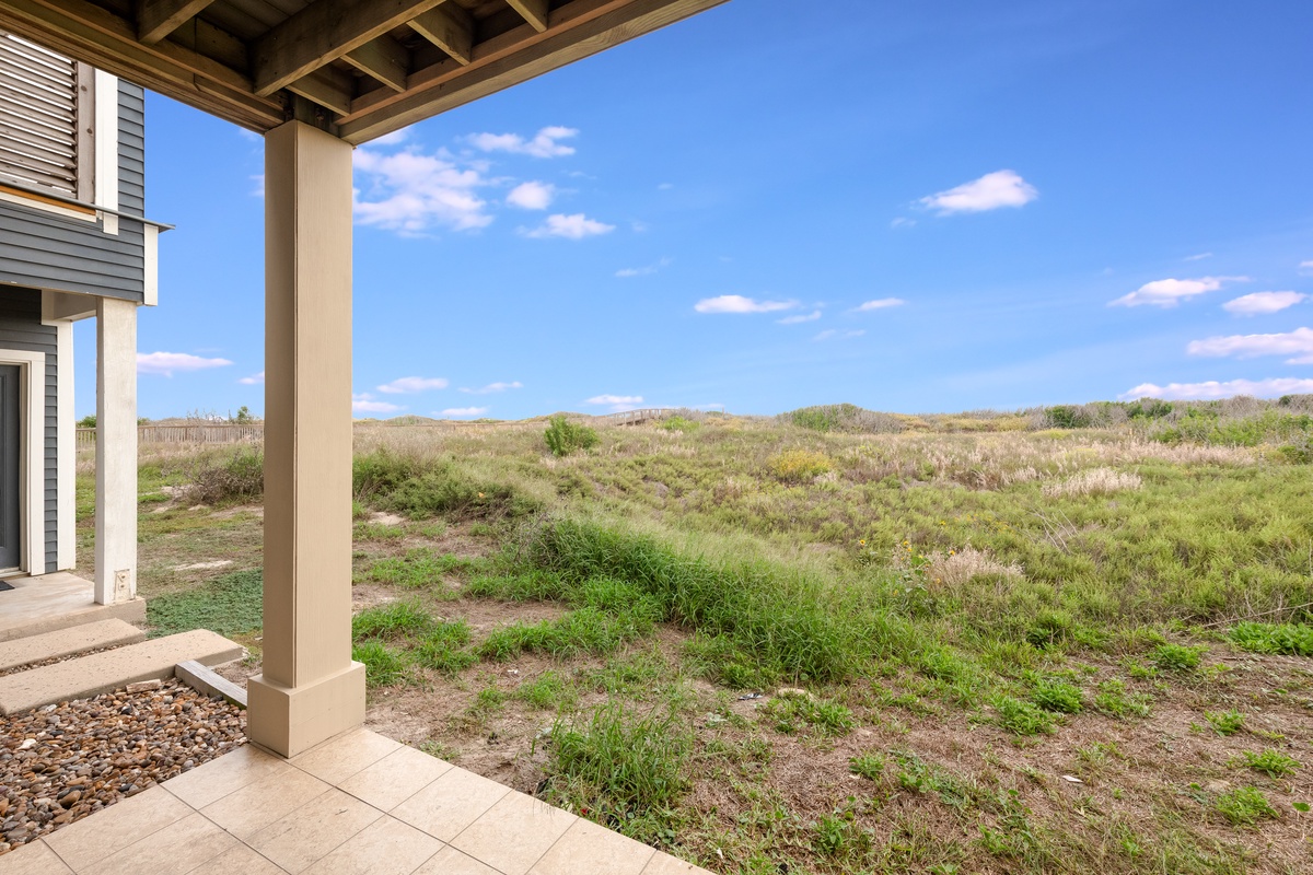 Your covered patio opens to sweeping natural grasslands, where you can sip morning coffee while watching the sky paint itself across endless meadows.