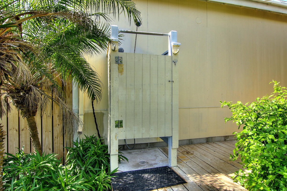 Rinse off in your private outdoor shower surrounded by tropical palms and lush greenery for the ultimate outdoor bathing experience.