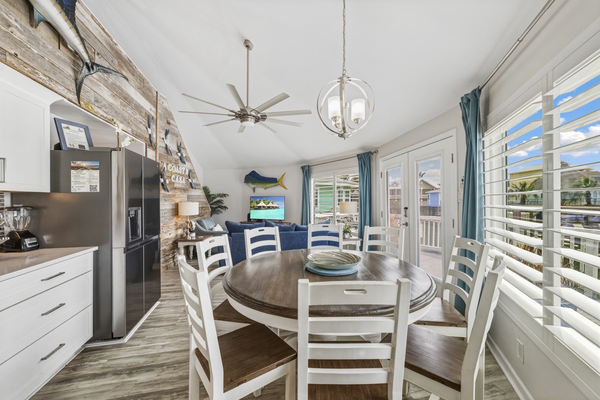 Gather around your spacious dining table where coastal charm meets modern comfort, perfect for memorable meals with ocean breezes flowing through.