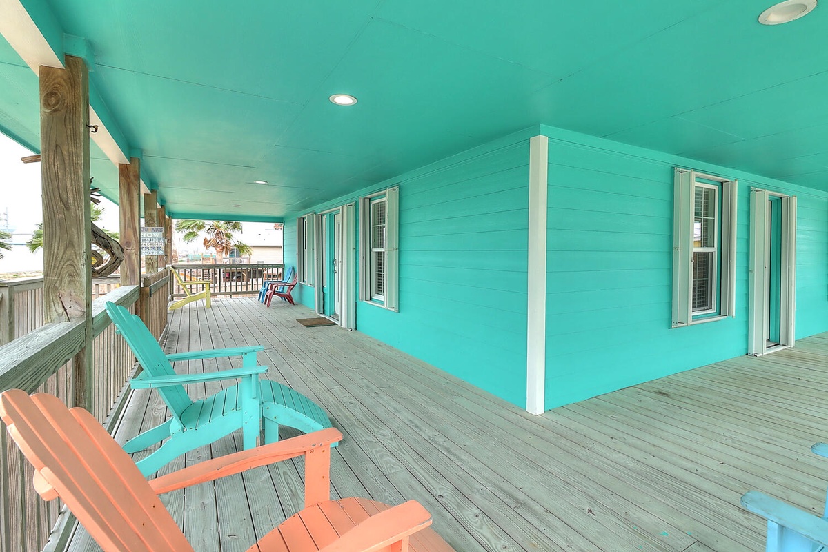 Relax on your bright turquoise-wrapped deck with colorful Adirondack chairs and tropical breezes flowing through.