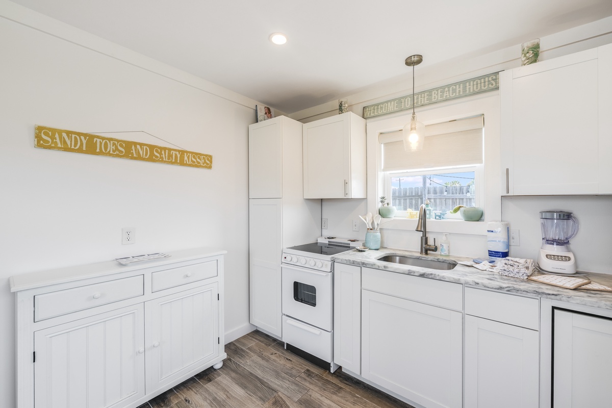 This charming coastal kitchen is stocked with everything you need to cook, dine, and make yourself at home during your stay.