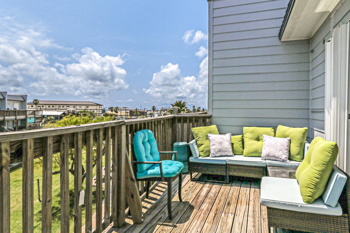 Unwind on your private deck with plush seating and vibrant cushions, perfect for morning coffee or sunset relaxation.